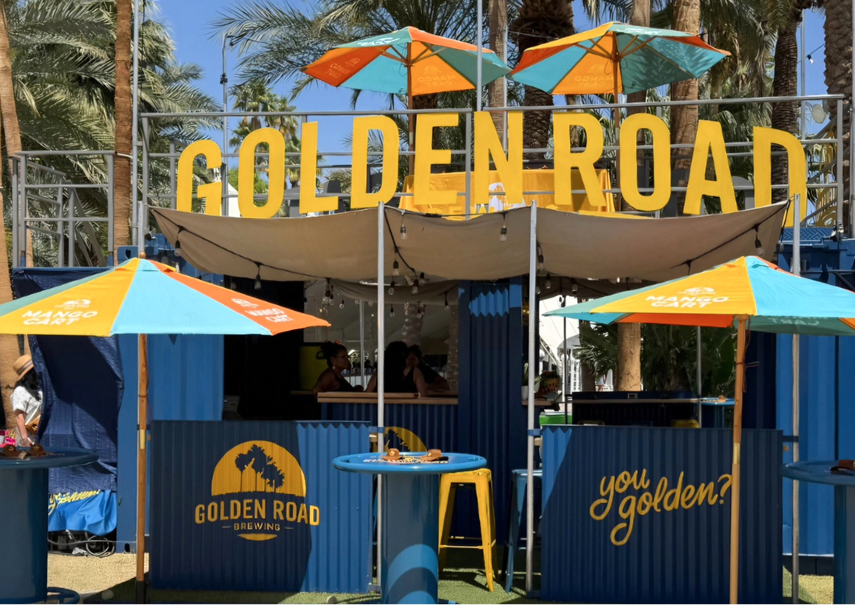 Golden Road pop-up event featuring custom tri-color branded umbrellas creating a vibrant outdoor act