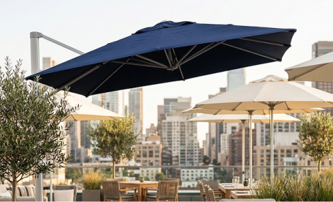 Umbrella Source navy blue cantilever umbrella on a rooftop seating area