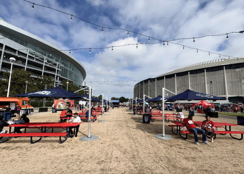 Houston Texans fan space featuring red picnic tables and custom branded cantilever umbrellas