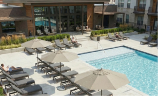 Umbrella Source umbrellas surrounding an apartment complex pool providing shaded resident seating.