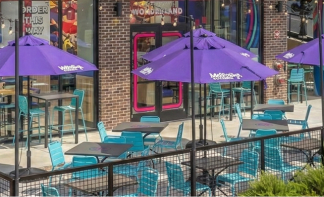 Custom branded purple logo umbrellas from Umbrella Source outside a Mellow Mushroom pizza restaurant
