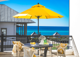 Rooftop ocean view at The Pearl Hotel with a yellow market umbrella.