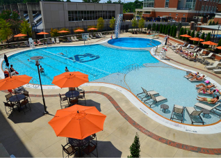 Auburn University Recreation and Wellness Center pool with custom orange market umbrellas